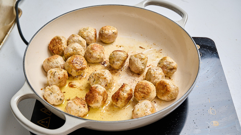 browning meatballs in a skillet