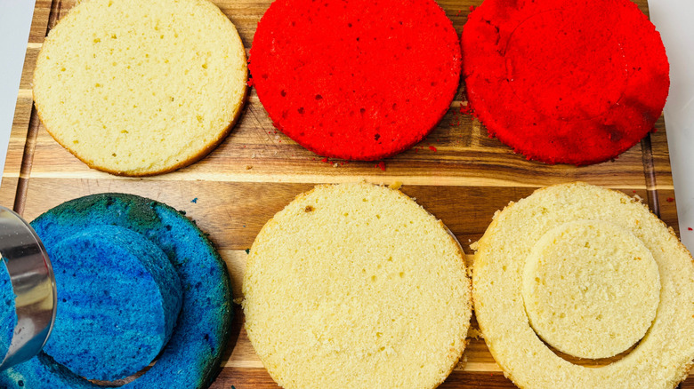 Red, white, and blue cake layers on wooden board