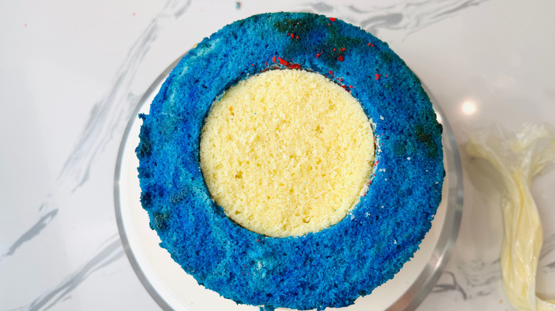 Cake with blue ring layer on outside and white layer in middle