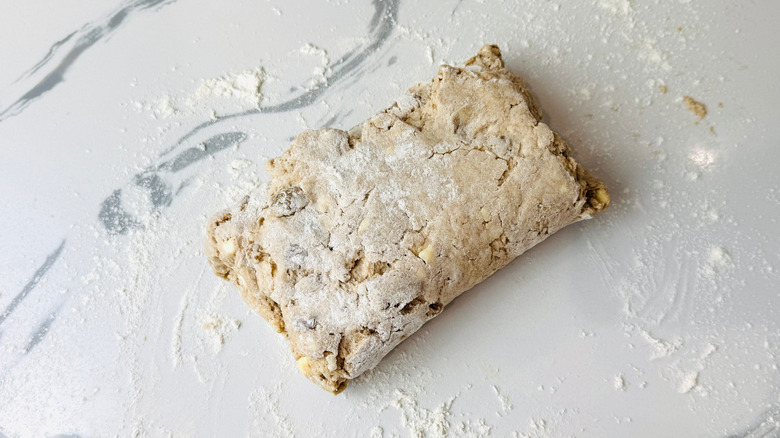 Folded biscuit dough on countertop