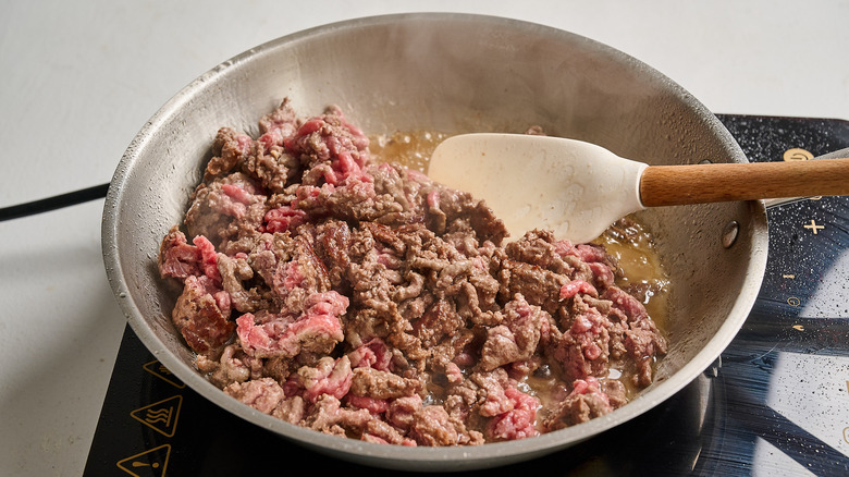 crumbling ground beef in a skillet