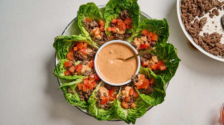 lettuce wraps topped with tomato and sauce