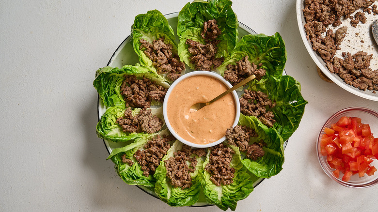 assembling the ground beef into lettuce wraps