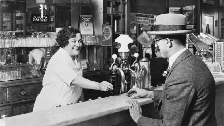 Coke being served at a soda fountain