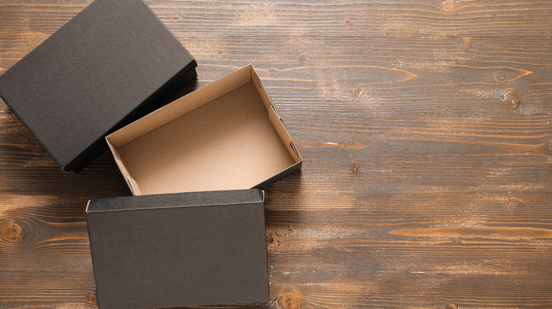 Black shoeboxes on wood