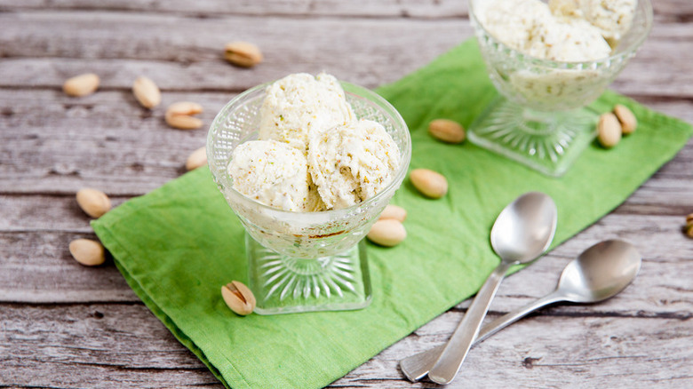 Scoops of pistachio ice cream in dessert glasses