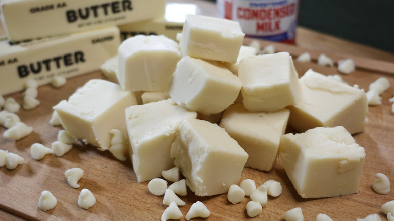 Pile of white chocolate fudge on wooden board