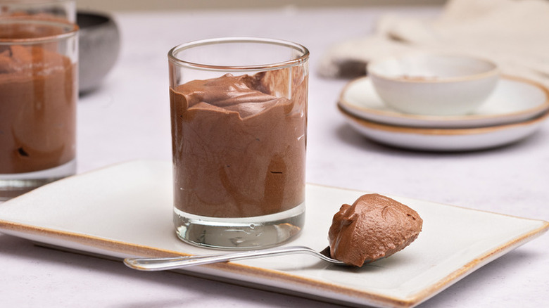 Chocolate mousse in dessert glass with spoonful in the side