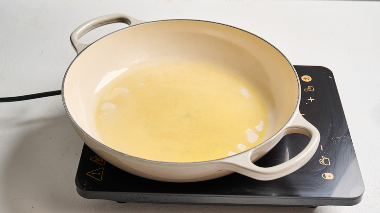 heating oil in a braising pan