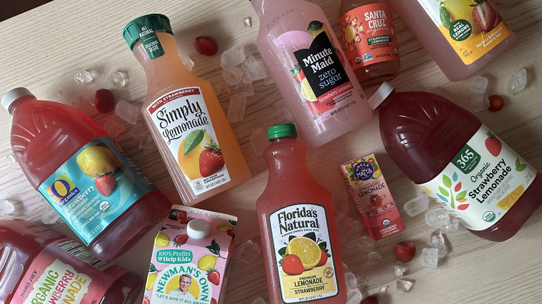 Bottles of strawberry lemonade on wooden table