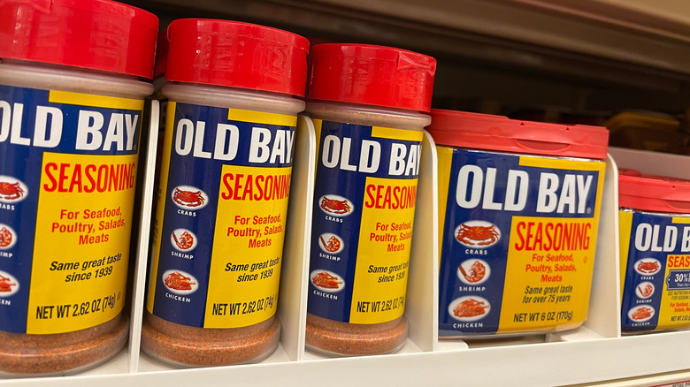 Tubs of Old Bay Seasoning on grocery store shelf