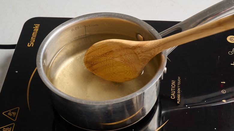 stirring water into sugar