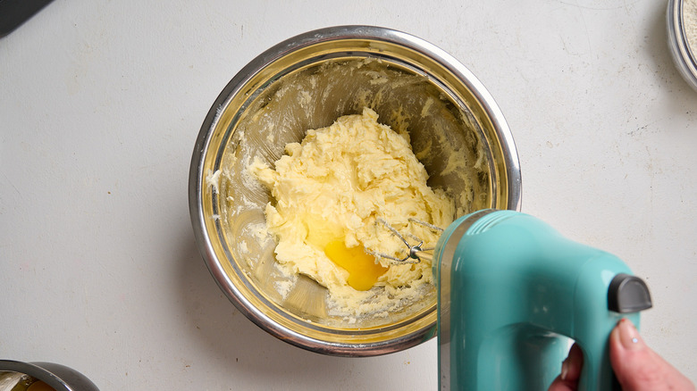 beating eggs into the creamed butter