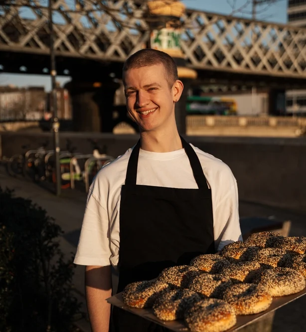 chef holding a tray of bagels