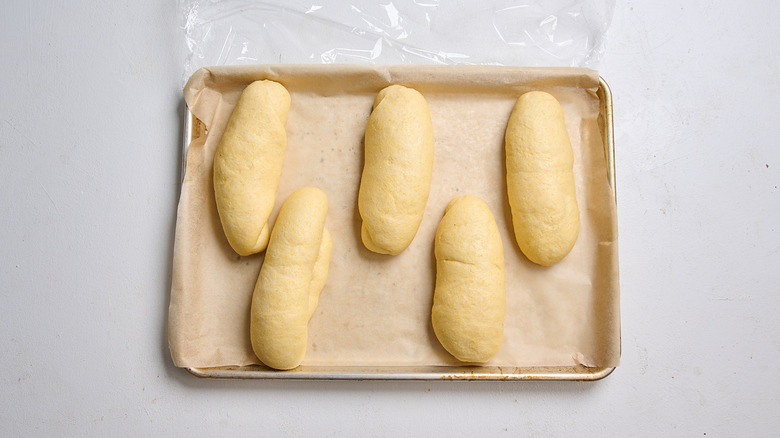 proofed hot dog buns on a sheet tray