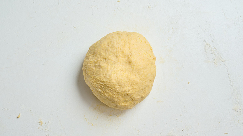 kneaded dough in a ball on a table