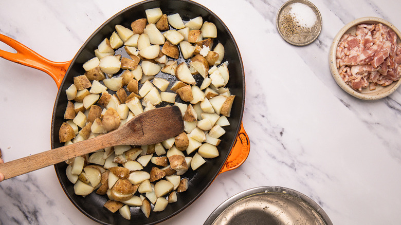 Cast iron pan with potatoes and lardons