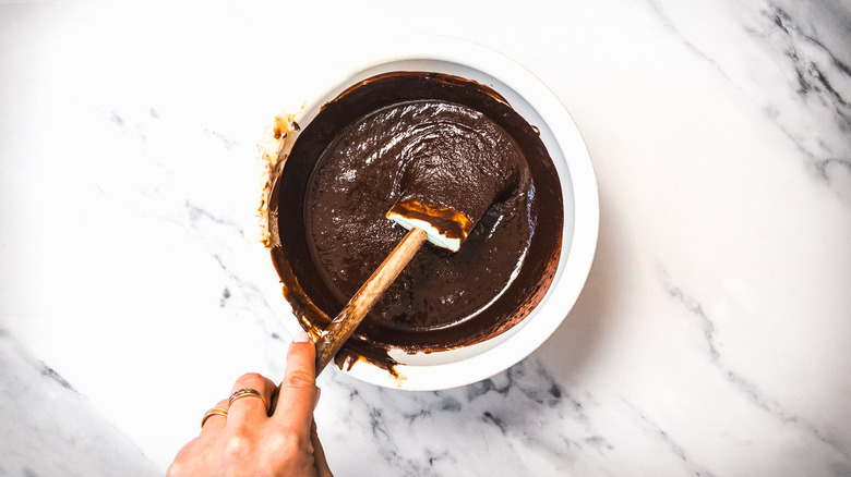 Stirring chocolate batter in bowl.