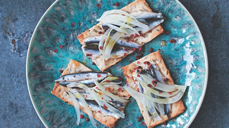 plate of crackers with fennel and anchovies