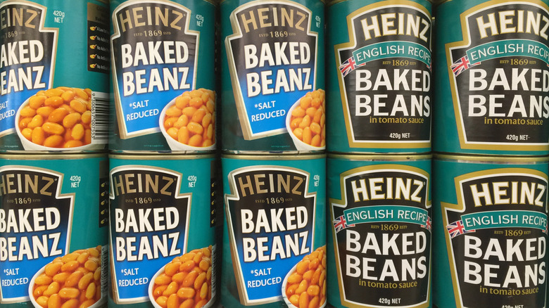 Cans of Heinz baked beans on a shelf