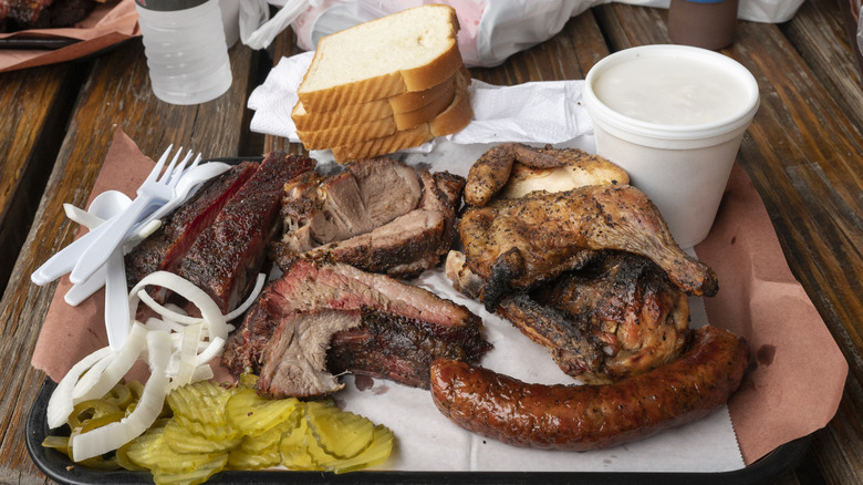 Barbecue platter with various traditional sides and bread