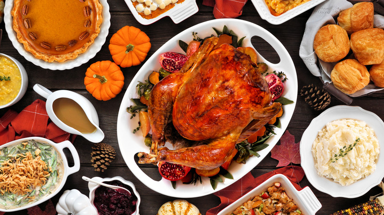 Turkey surrounded by traditional Thanksgiving side dishes