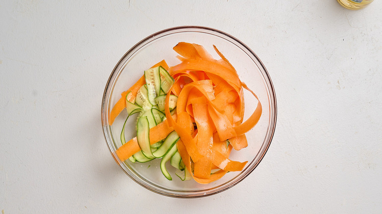 cucumbers and carrots salted in a bowl