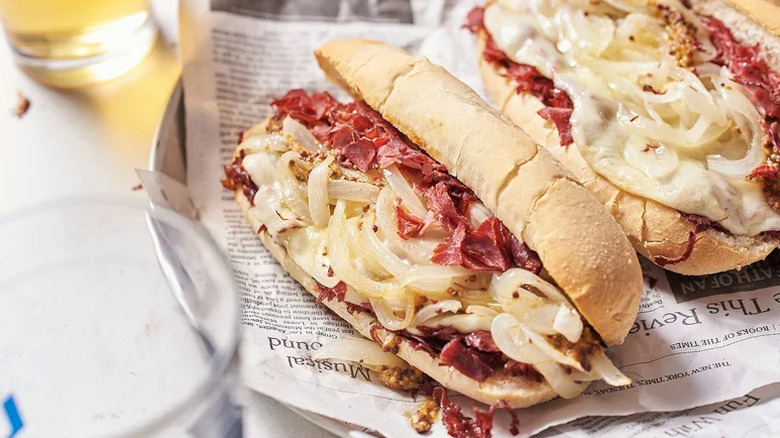Chopped Cheese-Style Pastrami Sandwich on plate lined with newspaper