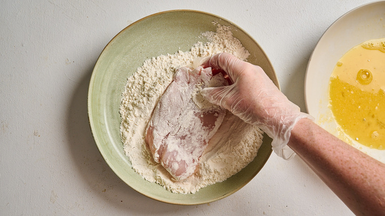 dredging chicken into flour