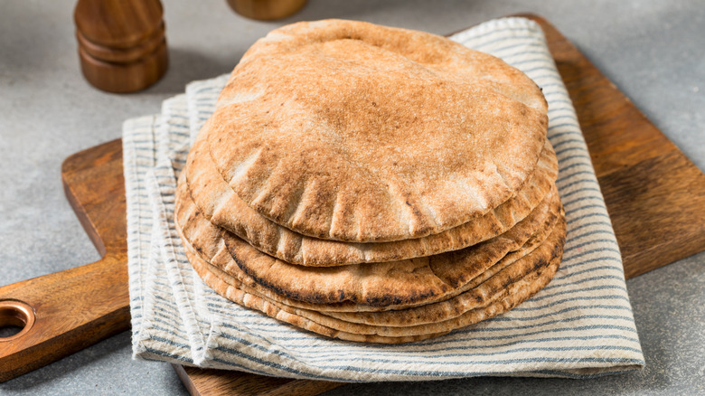 Stack of flatbread on wooden cutting board