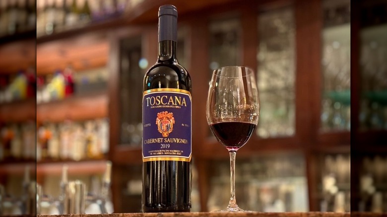 Bottle and glass of Fattoria La Lecciaia Cabernet Sauvignon in a restaurant