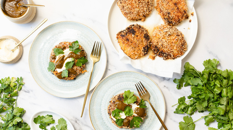 Two sweet potato crab cakes with mayonnaise and chermoula