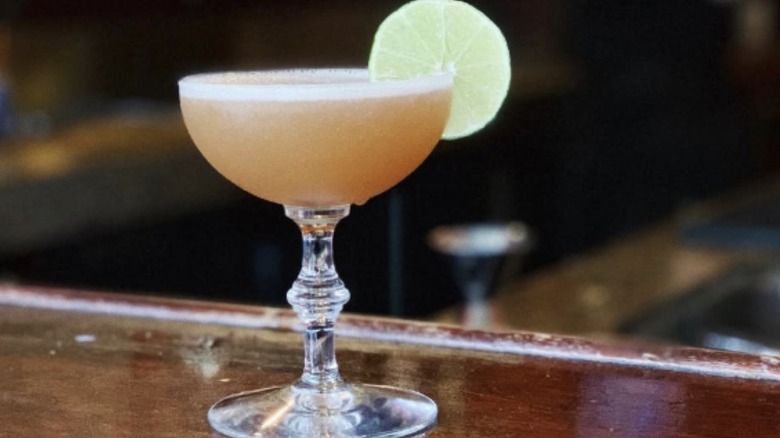 A Lion's Tail cocktail in an Art Deco coupe glass.