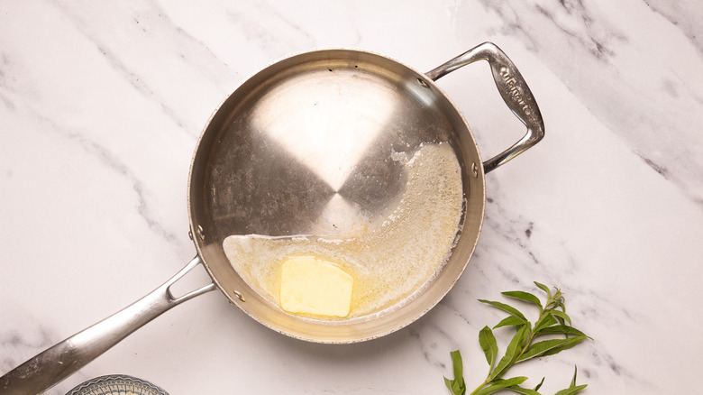Melting butter in skillet.