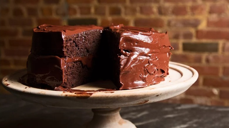 Chocolate layer cake on wooden cake stand
