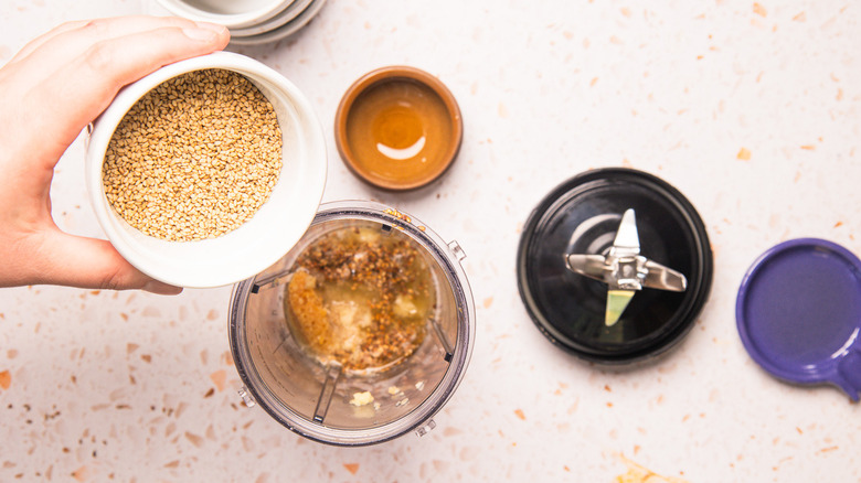 Adding sesame seeds to blender.