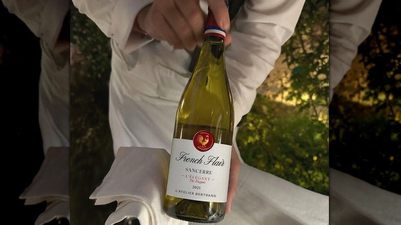 Person holding bottle of French Flair The Elegant Sancerre wine