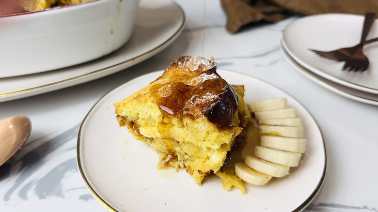 Slice of french toast bread pudding with bananas and maple