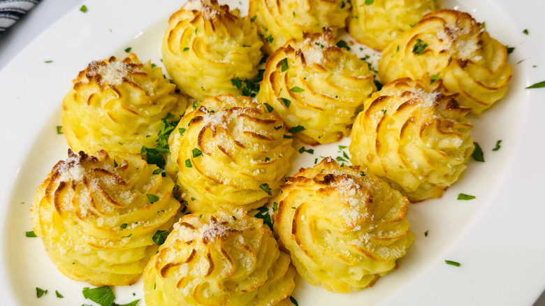 Garlic parmesan duchess potatoes on serving platter