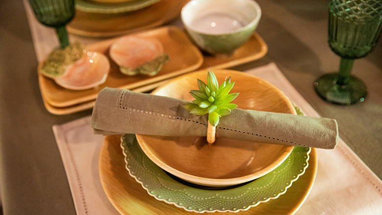 Plate with plastic plant sprig and silverware
