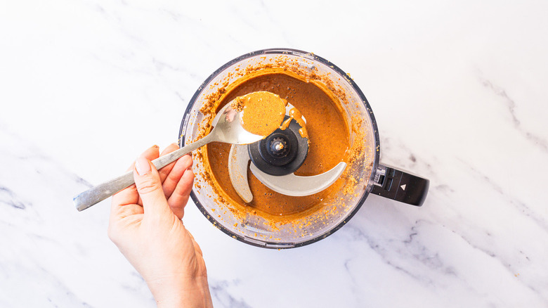 Lifting spoon with hazelnut butter from food processor