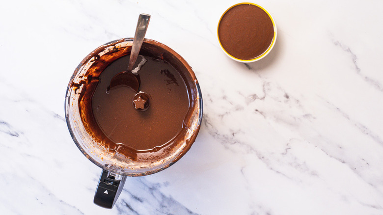 Lifting spoon with hazelnut butter from food processor