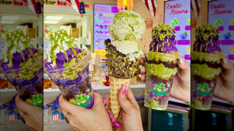 Three ice cream cones with neon signs behind it