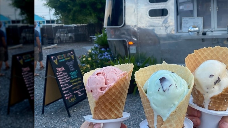 Three ice cream cones against a metal airstream