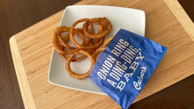 Big takeout box of crispy fried onion rings