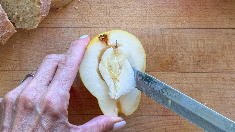 knife removing core from pear