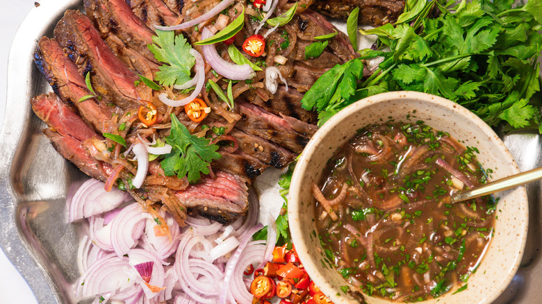 Close up on steak with herbs and toppings