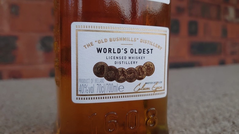 A close of of the bottom of Bushmills Original's front label, showcasing its claim to be the world's oldest licensed distillery