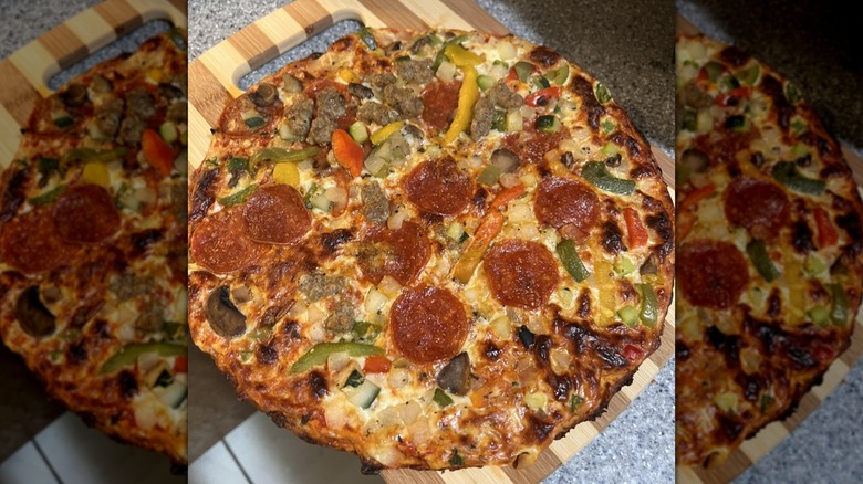Kirkland Signature cauliflower crust pizza on wooden cutting board