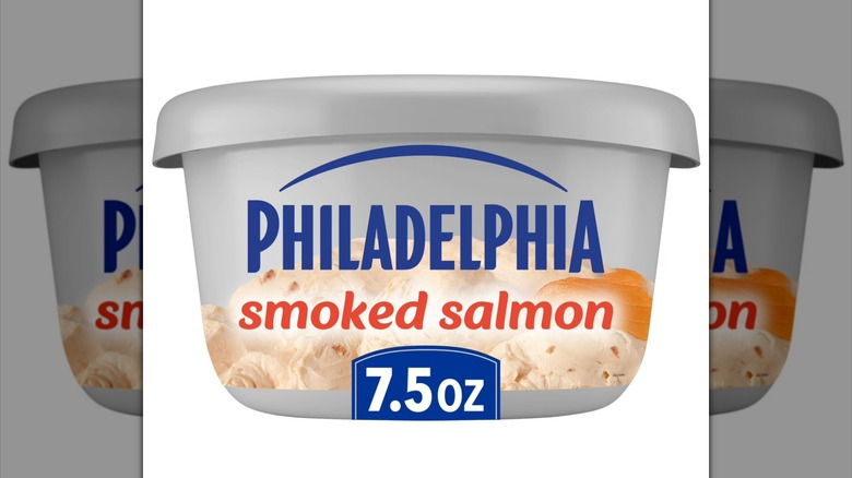Gray tub of Philadelphia Smoked Salmon Cream Cheese Spread on white background.